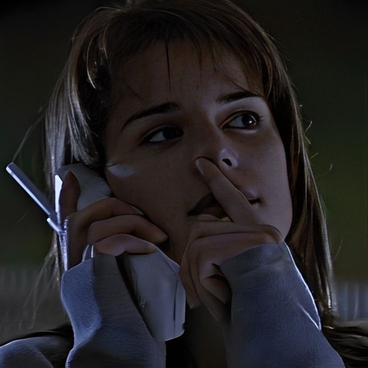 a woman holding a cell phone up to her face