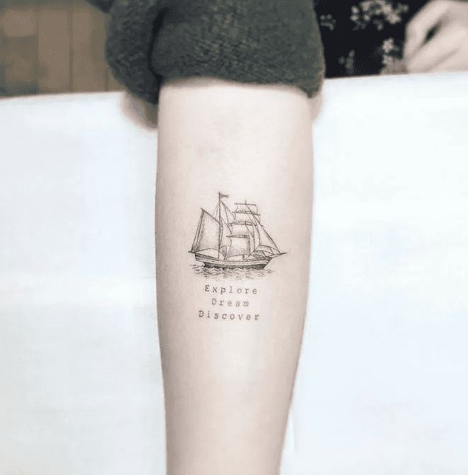 a woman's arm with a ship tattoo on the left side of her leg