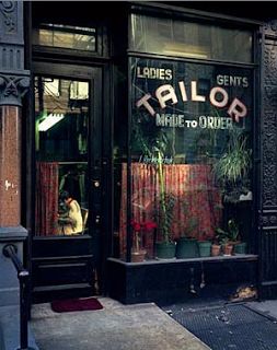 a store front with plants in the window