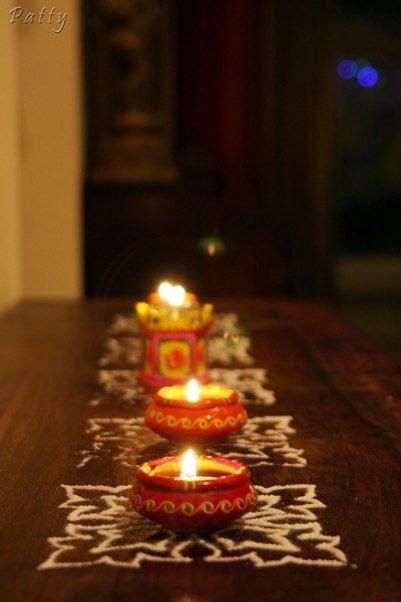 three lit candles sitting on top of a wooden table