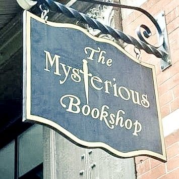 the mysterious bookshop sign is hanging from the side of a building