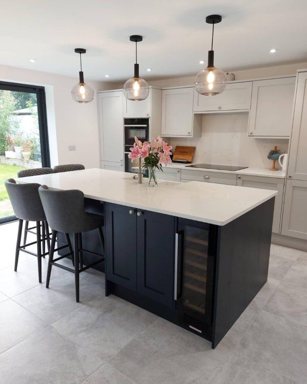 a large kitchen with an island and bar stools