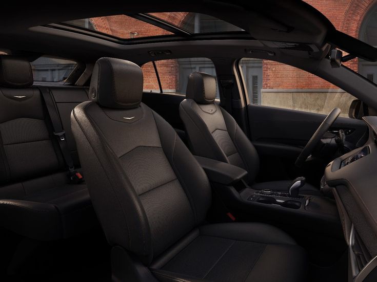 the interior of a car with black leather seats