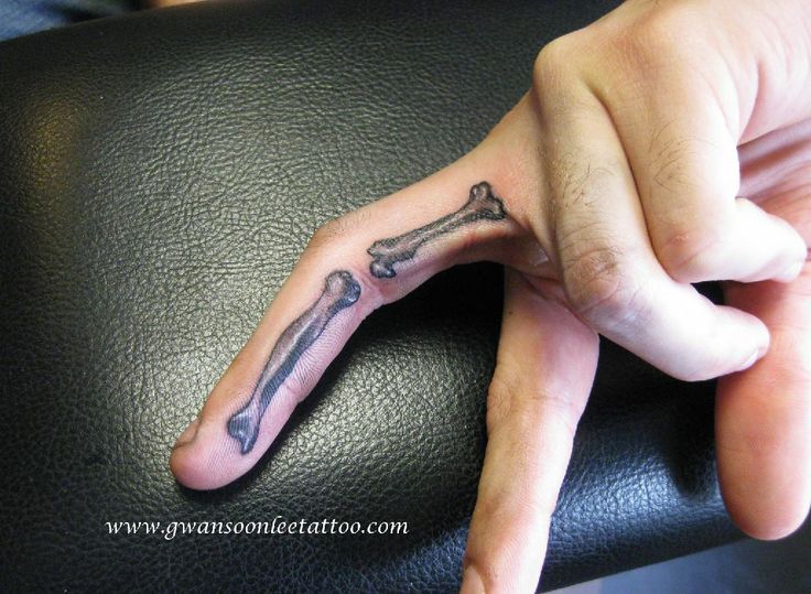 a person's hand with a tattoo on it and a cross in the middle