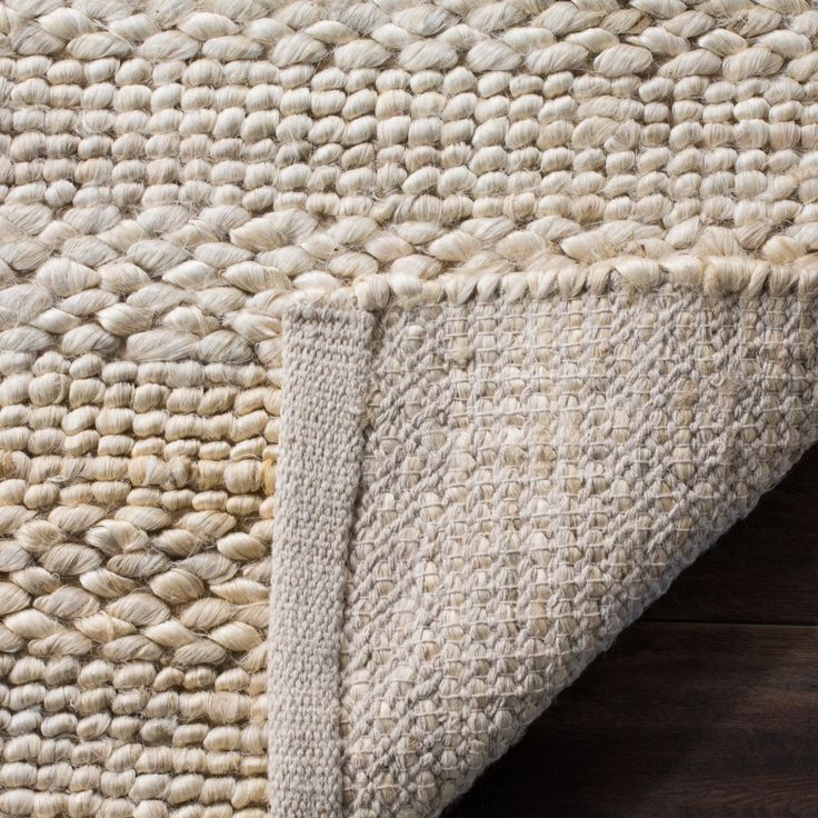 an area rug with white and beige colors