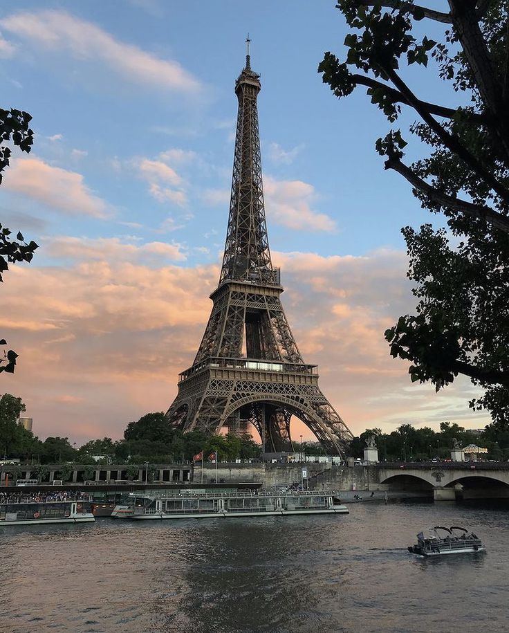 the eiffel tower towering over the river seine in paris, france at sunset