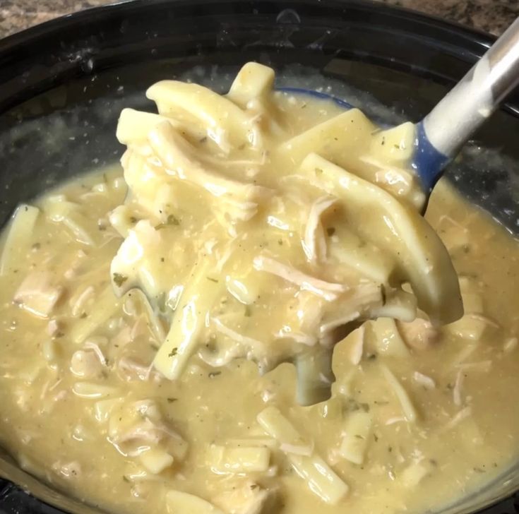 a close up of food in a pot with a spoon