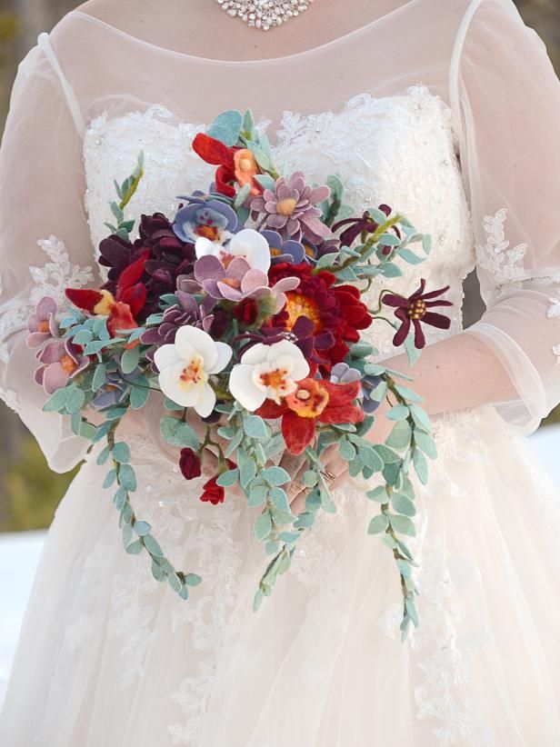 a woman in a wedding dress holding a bouquet of flowers