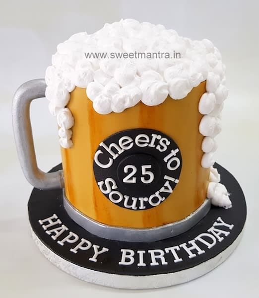 a cake shaped like a beer mug with happy birthday written on it