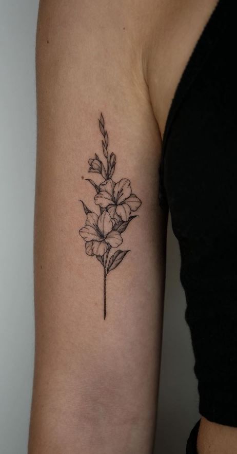 a black and white flower tattoo on the arm