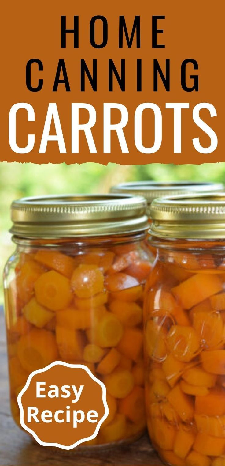 two jars filled with carrots sitting on top of a wooden table