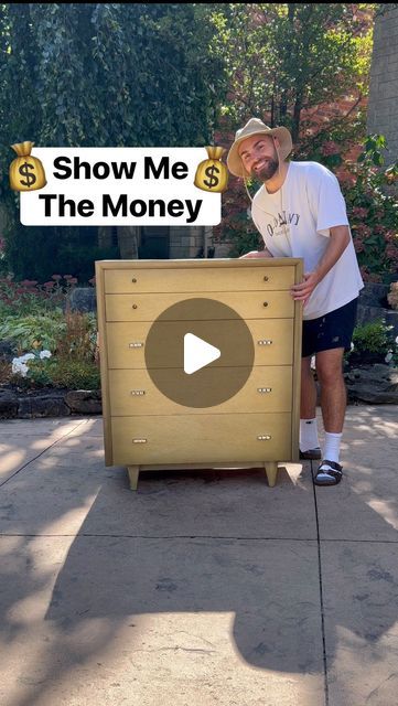 a man standing next to a wooden chest with money on it and the words show me the money