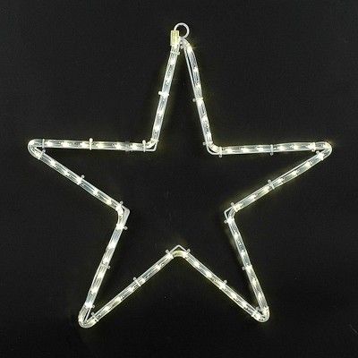 a lighted star ornament on a black background