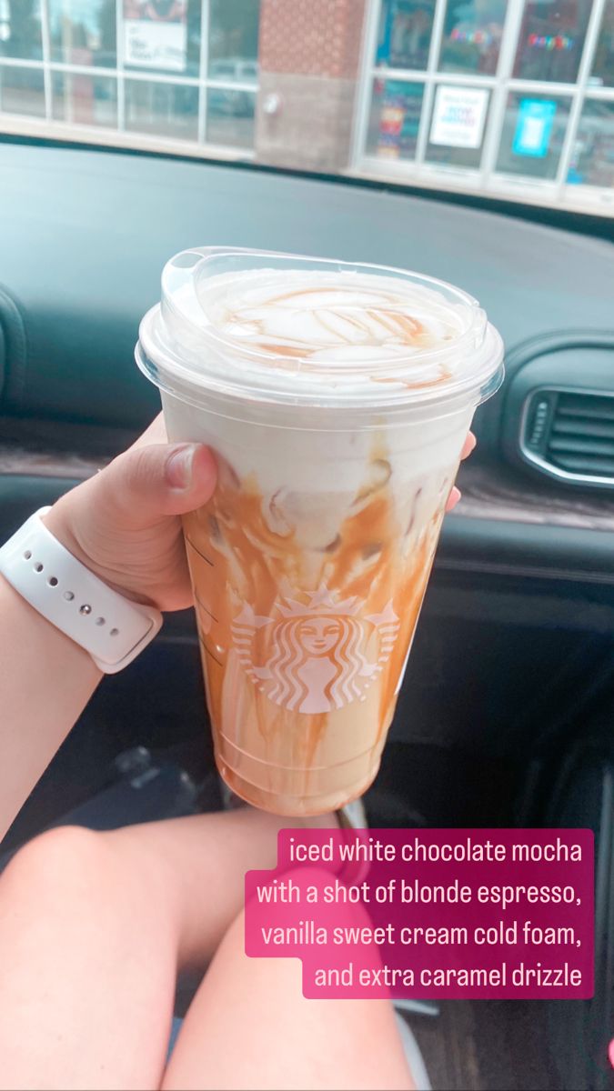 a woman holding up a cup of coffee in her hand with the caption iced white chocolate mocha with a shot of blonde espresso, vanilla sweet cream cold foam