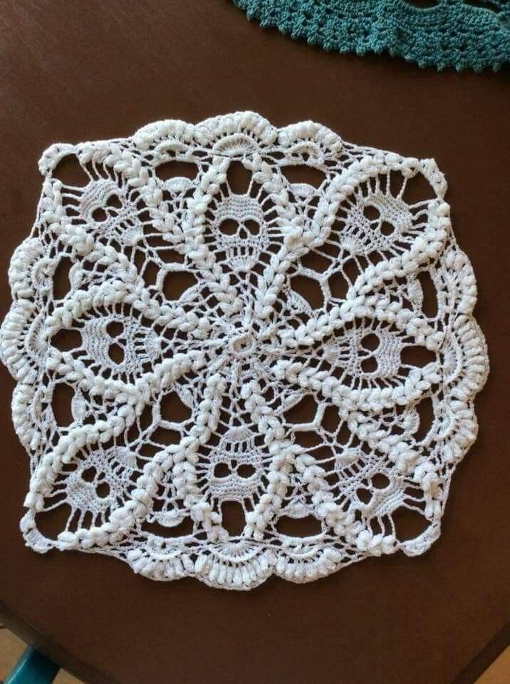 two crocheted doily sitting on top of a table