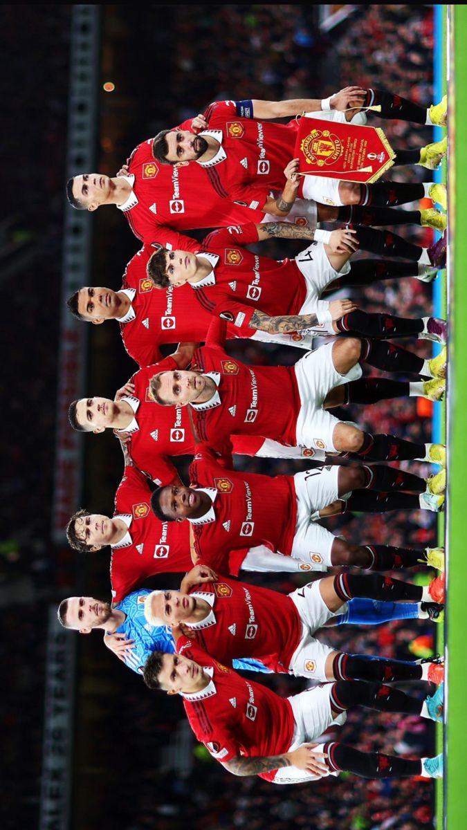 the liverpool united team line up for their national soccer team photo in front of an empty stadium