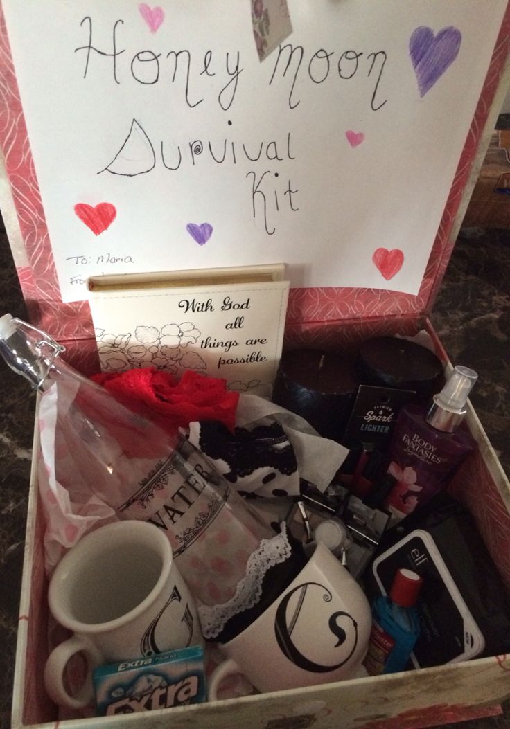 a box filled with personal items and a sign that says honey moon survival kit