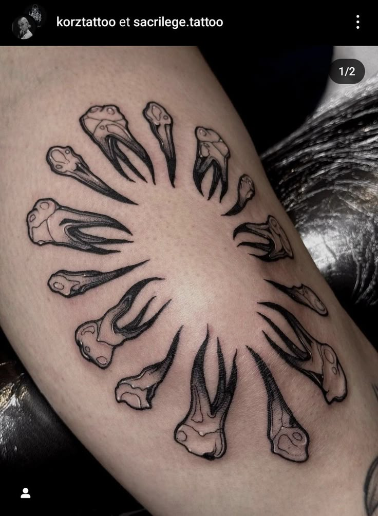 a tattoo with many bones on the side of it's leg, and in the center there is a circle of bones