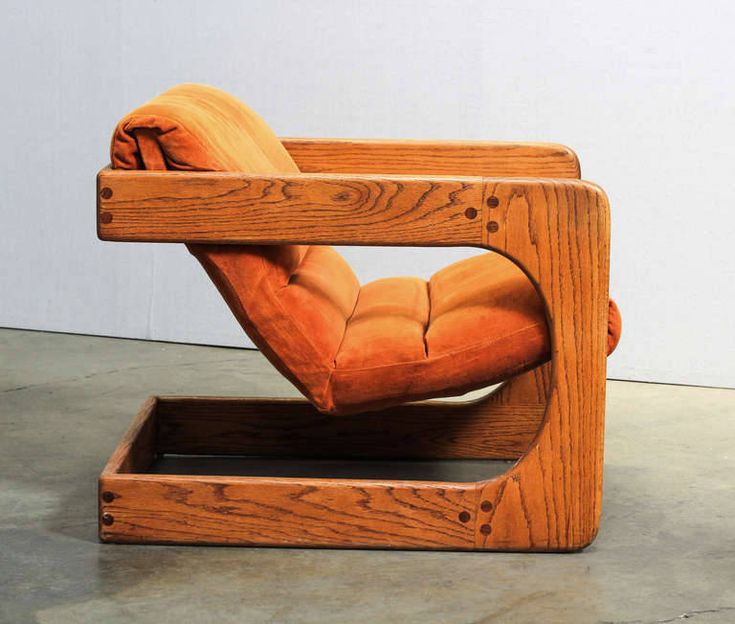 a wooden chair that is shaped like a reclining chair with one arm folded over the back