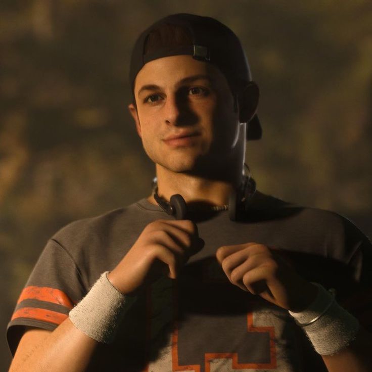 a young man is adjusting his shirt in the dark, wearing a football jersey and cap