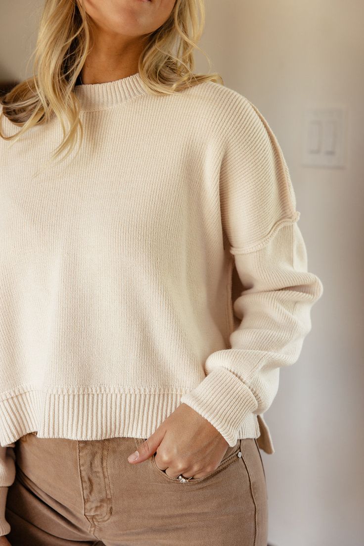 Featuring a drop-shoulder, ribbed material, and a high-low silhouette, the Leda Slouchy Pullover comes in two natural colors that are perfect for Fall. Pair easily with anything in your closet and be extra comfy in this slouchy pullover! high-low side slits black // paired with the sabine high rise wide leg jeans ivory // paired with the stellan wide leg pants Everyday Spring Sweater With Ribbed Neckline, Spring Everyday Sweater With Ribbed Neckline, Spring Sweater With Ribbed Neckline, Cozy Oversized Cropped Sweater With Ribbed Neckline, Oversized Cozy Cropped Sweater With Ribbed Neckline, Oversized Cropped Sweater With Ribbed Neckline, Cozy Cropped Sweater With Ribbed Neckline For Layering, Oversized Ribbed Cropped Sweater For Layering, Beige Sweater With Ribbed Neckline For Layering