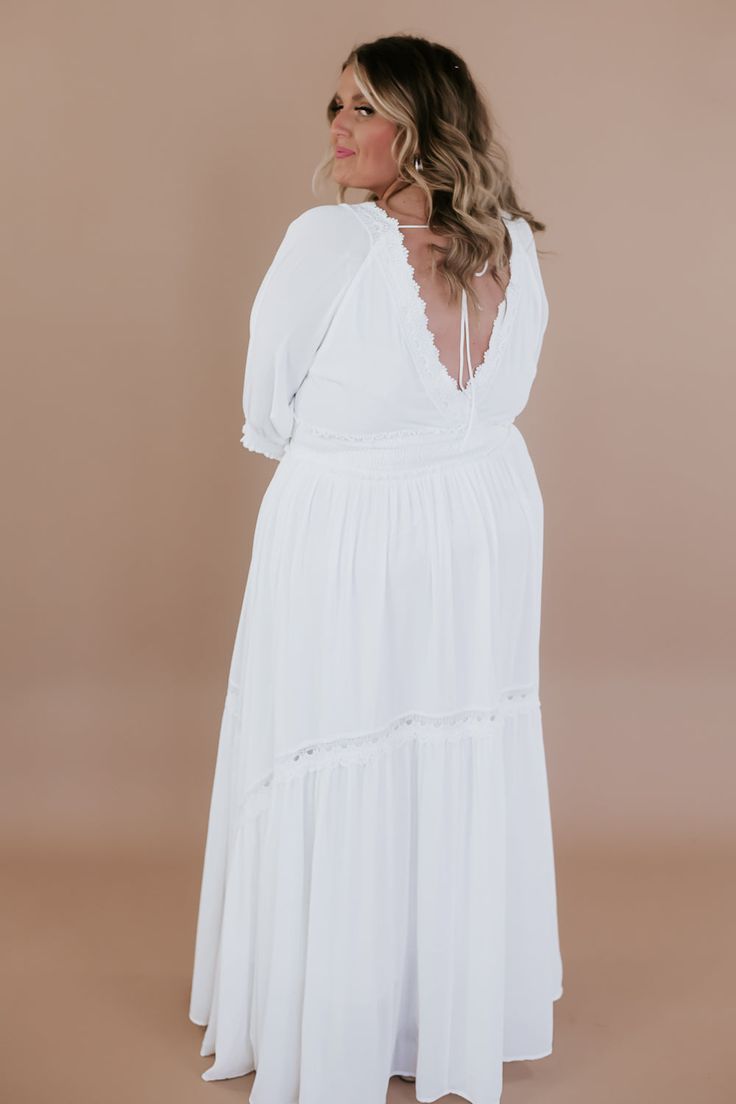 ECB Exclusive: Most Admired Maxi Dress in White. Crafted with meticulous attention to detail, this dress exudes elegance with its classic silhouette and flattering fit. The crisp white hue lends a touch of sophistication, while delicate lace detailing and intricate embroidery add a romantic and feminine allure. Perfect for a variety of occasions, it's sure to turn heads and leave a lasting impression wherever you go. Elevate your wardrobe with this timeless piece and make every moment unforgettable. Family photoshoot maxi dress Photoshoot dresses for moms Bride Casual Maxi Dress Neckline: Lace V Fabric: 100% polyester; Lining: 100% Polyester Cinched waistline Lined mid-length cuffed sleeve lace detailing adjustable tie back Fit: True to size, if in between we recommend sizing down before u Elegant White Maxi Dress For Daywear, White Elegant Maxi Dress With Lace Trim, White Maxi Length Dress With Lace Trim, Classic Fitted White Maxi Dress, Classic White Fitted Maxi Dress, White Fitted Empire Waist Dress, Elegant Empire Waist Maxi Dress For Brunch, White Fitted Empire Waist Maxi Dress, White Feminine Empire Waist Midi Dress