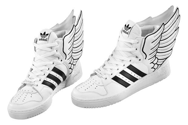 a pair of white sneakers with wings on them