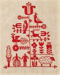 a red and white cross stitched christmas tree with birds, flowers, and animals