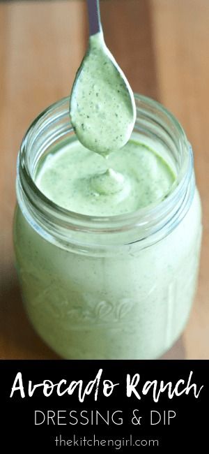 a spoon full of green dressing on top of a wooden table with the words arocado ranch dressing and dip