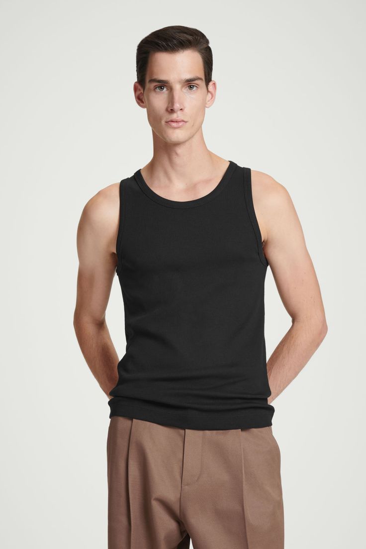 This ribbed tank top is the perfect basic to wear on its own or layered underneath overshirts and cardigans. Spun from soft organic cotton-blend jersey, it's cut for a slim fit and has a scooped neck and wide armholes for comfort. - Organic cotton is grown from non-genetically modified seeds without chemical fertilizers or pesticides Shell: 70% Organic cotton, 25% Recycled cotton, 5% Elastane. Excluding trims / Machine wash Back length of size M is 69.6cm / Model wears a size M Basic Everyday Cotton Tank Top, Basic Cotton Tank Top For Summer, Classic Ribbed Tank Top For Spring, Black Ribbed Cotton Top, Ribbed Vest For Everyday Spring Wear, Casual Cotton Ribbed Tank Top, Cotton Crew Neck Tank Top With Ribbing, Casual Ribbed Cotton Tank Top, Casual Ribbed Tops For Layering