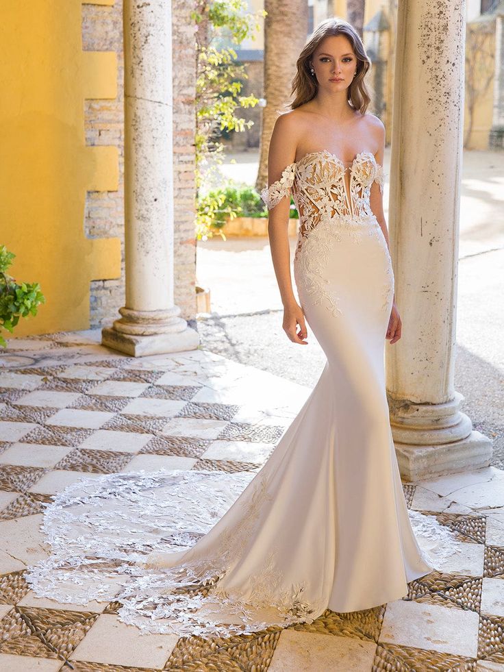 a woman in a white wedding dress standing on a checkerboard floor with columns