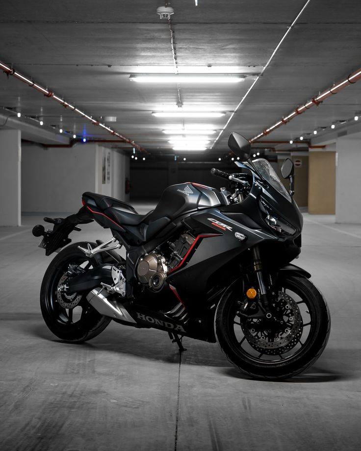 a motorcycle is parked in an empty parking garage