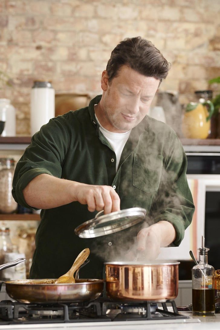 a man is cooking in a pot on the stove with steam coming out of it