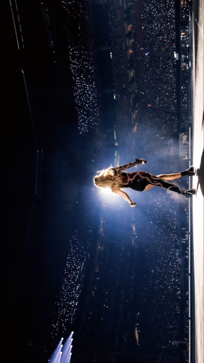 a woman is floating in the air on top of a building with raindrops