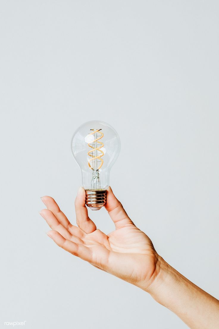 a person's hand holding an electric light bulb