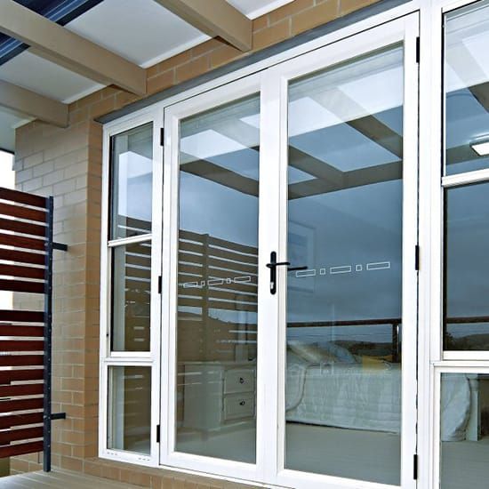 an open window on the outside of a building with wood slats and white trim