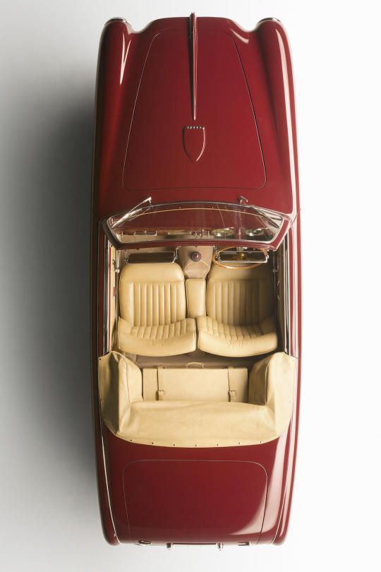 the interior of a red car with two seats and an overhead view of the floor