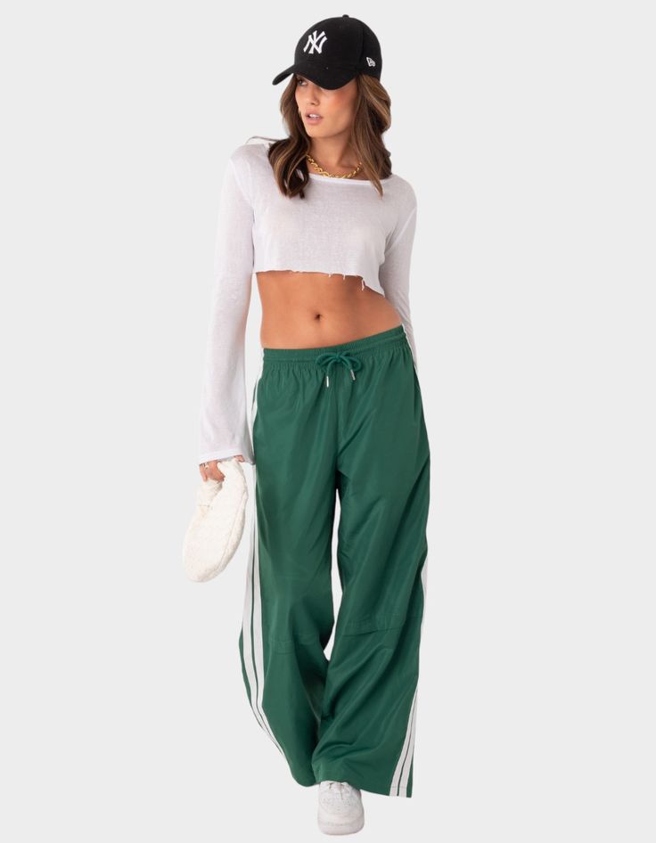 These Nylon Track Pants Offer Both Style And Comfort, Making Them Perfect For A Sporty Yet Fashionable Look. They're Ideal For Any Activity, Ensuring You Feel Comfortable And Confident Throughout Your Entire Day. Track Pants. Side Stripe Detail. Drawstring Waistband. 100% Polyester. Item Care: Wash With Similar Colors. Model Wears Size S. Model Height Is 5'8. | Edikted Fauna Nylon Track Pants Nylon Track Pants, Track Pants Outfit, Track Pants Women, Side Stripe, Sport Pants, Pants Outfit, S Models, Fashion Pants, Track Pants