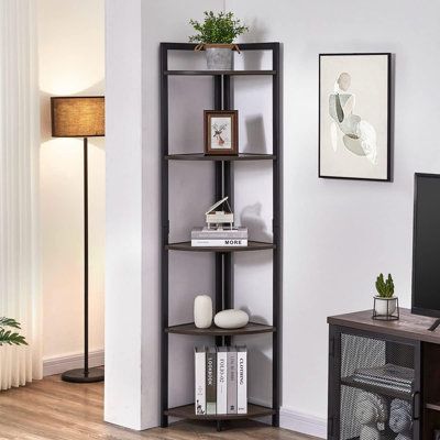 a living room with a tv and book shelf