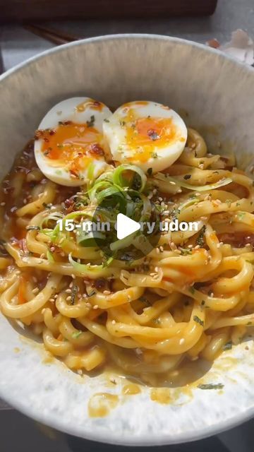 a bowl filled with noodles and hard boiled eggs