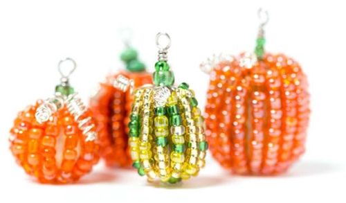 three beaded pumpkins sitting next to each other