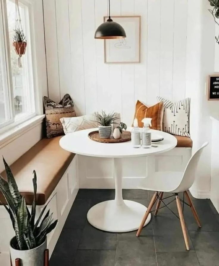 the instagram page shows an image of a dining room with white walls and black flooring