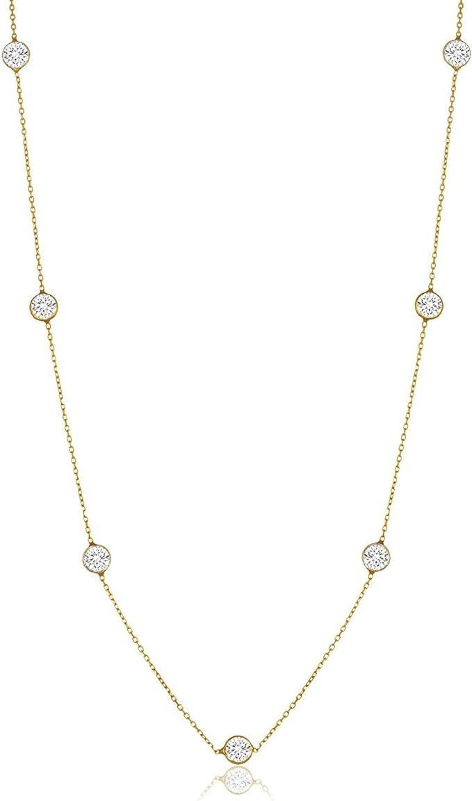 TIMELESS AND LUXURIOUS: This beautiful station necklace features a delicate strand of bezel set round brilliant cut lab created diamonds. It captures attention, making it a statement necklace piece for any occasion. PROFESSIONAL CRAFTMANSHIP: Meticulously crafted using high-grade hypoallergenic stainless steel, this elevated station necklace is a step above your traditional station necklaces featuring larger stones. With each stone measuring 5mm, you are guaranteed to shine and stand out from the crowd! VERSATILE SOPHISTICATION: Effortlessly transition from day to night with this versatile necklace. This clemence necklace is a universal 16 inch length with a 2 inch extension so you can adjust to your preferred style and fit. Wear it shorter if you prefer more of a choker style necklace or Real Ruby Necklace, Diamond By The Yard, Amazon Jewelry, Layered Choker Necklace, Choker Style Necklace, Ashes Jewelry, Hypoallergenic Jewelry, Station Necklace, Lab Created Diamonds