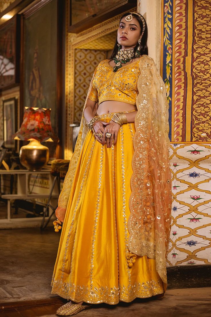 Mustard yellow lehenga in silk base with floral motif embroidery in marori, mirror and zardozi work. Paired with embroidered blouse and organza dupatta.
Components:3
Pattern:Embroidered
Type of Work:Floral Motifs
Neckline:V-Neck
Sleeve Length:Half
Fabric:Silk, Organza
Color:Red
Other Details:
Floral motifs
Scalloped hem lehenga and dupatta
Tassel edged dupatta
Note: The saree worn by the other model is not for sale
Occasion:Bride, Wedding - Aza Fashions Mustard Yellow Lehenga, Motif Embroidery, Zardozi Work, Yellow Lehenga, Party Wear Indian Dresses, Organza Dupatta, Silk Organza, Fabric Silk, Red Silk