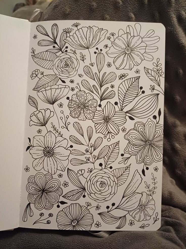 an open book with flowers drawn on it