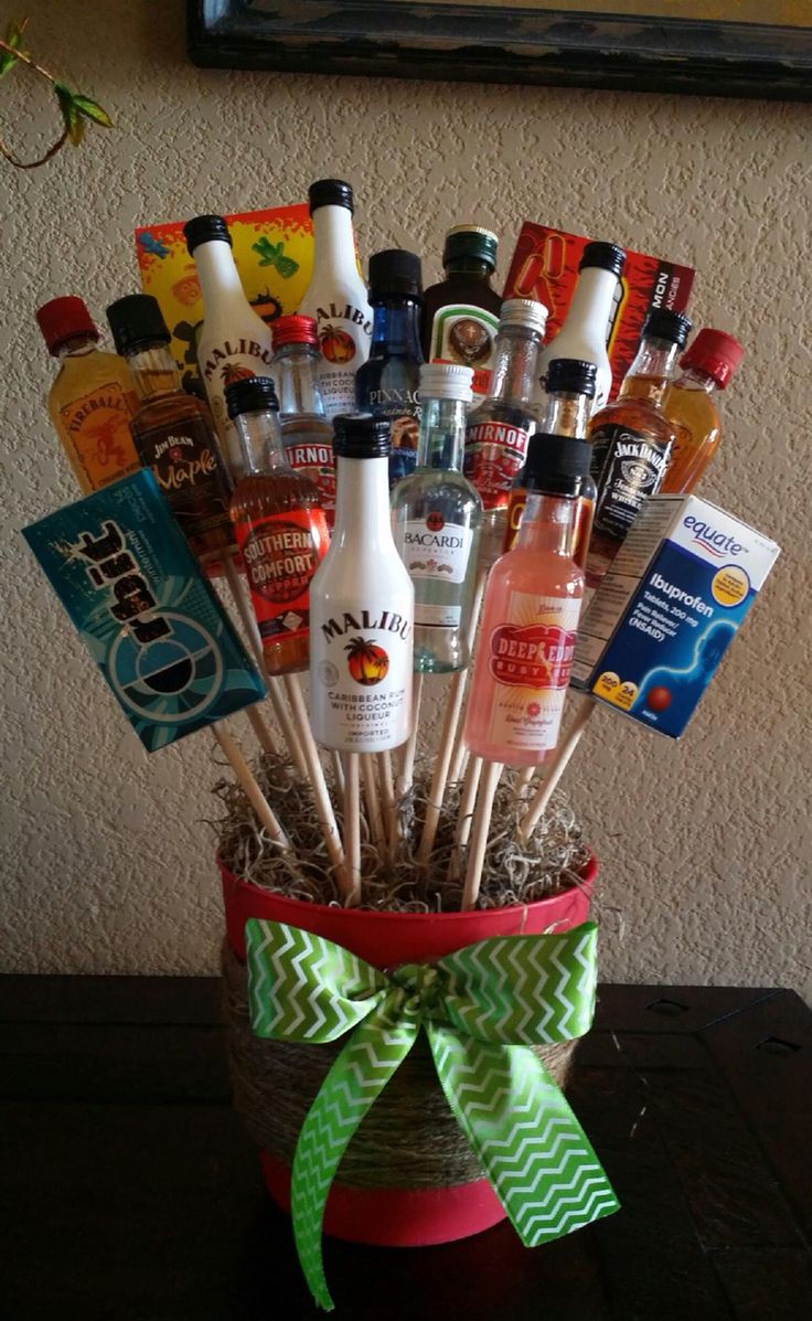 a basket filled with liquor bottles sitting on top of a table next to a wall