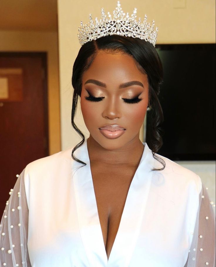 a woman wearing a tiara with pearls on her head