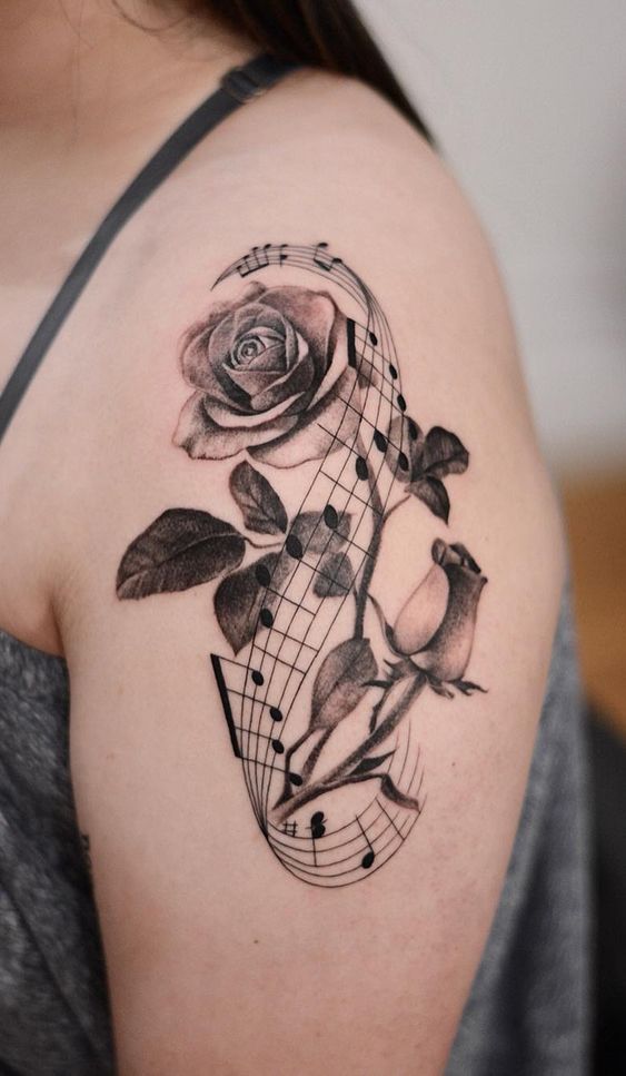 a woman with a rose and music notes tattoo on her shoulder