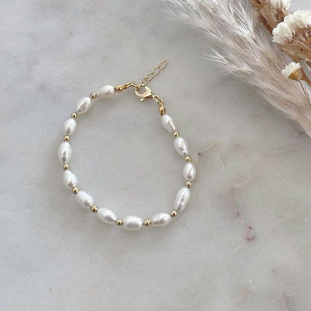 feel as if you're diving into the ocean with this one. we've fallin' for this sweet, classic piece. a fresh twist on the classic pearl bracelet is here, featuring freshwater baroque pearls with 14kt gold filled accents. pair it with your existing arm party to create some added texture. 14k US gold filled freshwater pearls are approximately 6mm beads are 3mm 7" with a .5" extender White Pearl Drop Bracelet In 14k Gold Filled, Everyday Baroque Pearl Bracelet With Pearl Charm, 14k Gold Filled White Pearl Drop Bracelets, White 14k Gold Filled Pearl Drop Bracelets, White 14k Gold-filled Pearl Drop Bracelets, Everyday Pearl Bracelet With Pearl Drop, 14k Gold Filled Pearl Bracelet With Round Beads, 14k Gold-filled Pearl Bracelet With Round Beads, Adjustable Baroque Pearl Beaded Bracelets With Pearl Drop