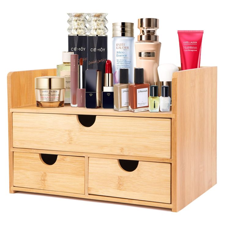 a wooden drawer with many different types of cosmetics in it and some bottles on top